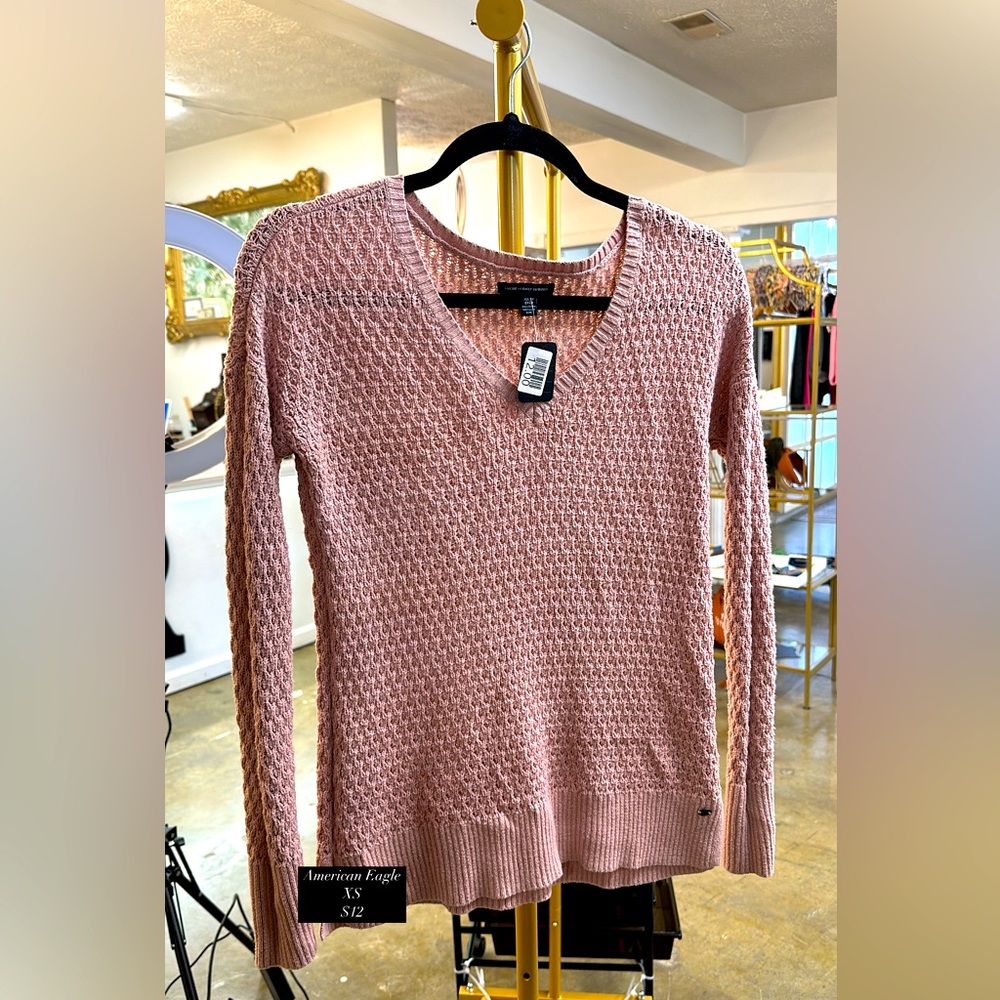 A cute V neck pale pink sweater.